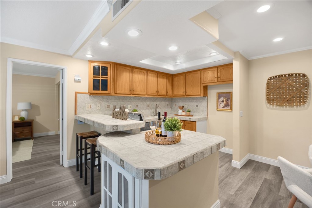 3020 Associated Road, Unit 110 Fullerton, CA 92835 - Photo 2 of 34 a kitchen with a sink cabinets and wooden floor
