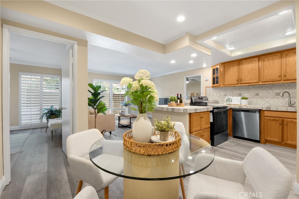 3020 Associated Road, Unit 110 Fullerton, CA 92835 - Photo 22 of 34 a kitchen with a table and chairs