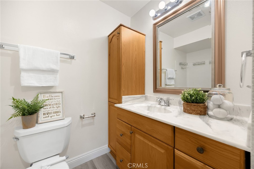 3020 Associated Road, Unit 110 Fullerton, CA 92835 - Photo 24 of 34 a bathroom with a granite countertop sink and a mirror