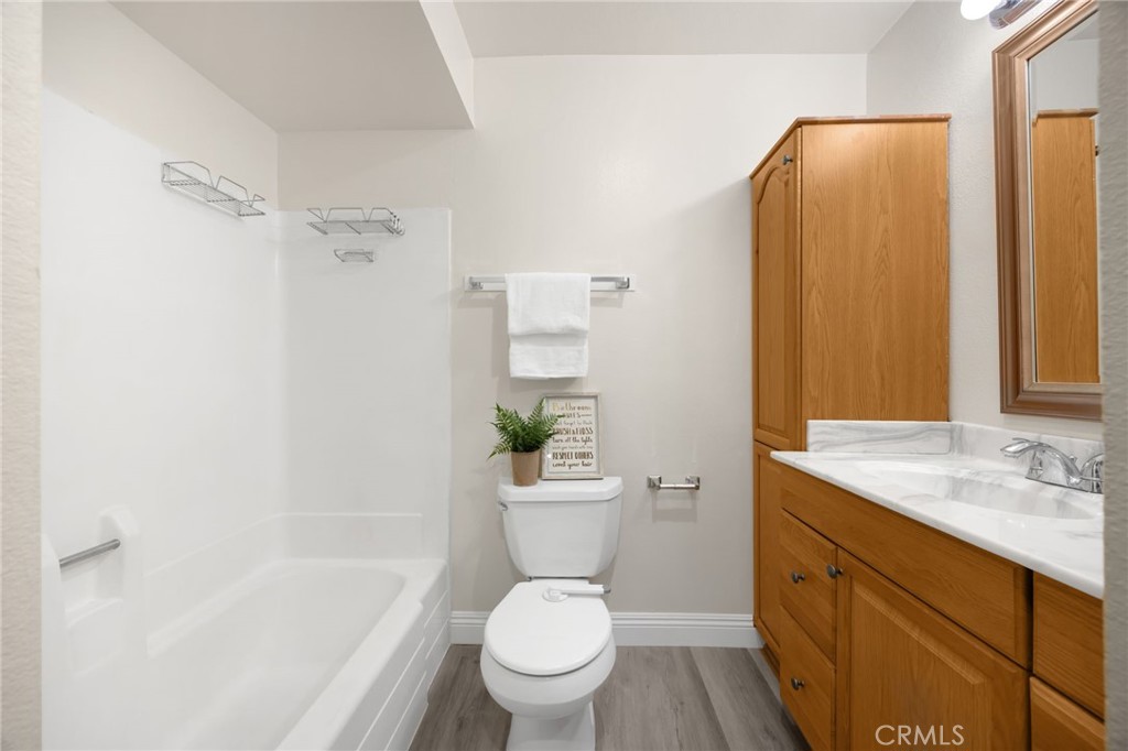 3020 Associated Road, Unit 110 Fullerton, CA 92835 - Photo 25 of 34 a bathroom with a sink a toilet and shower