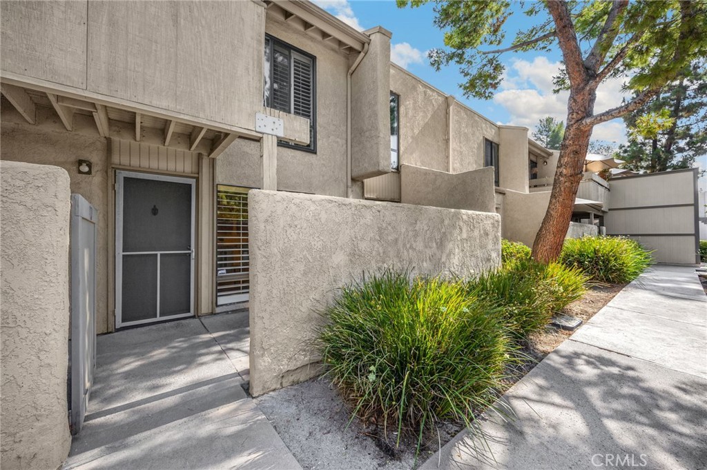 3020 Associated Road, Unit 110 Fullerton, CA 92835 - Photo 5 of 34 a front view of a house with a yard