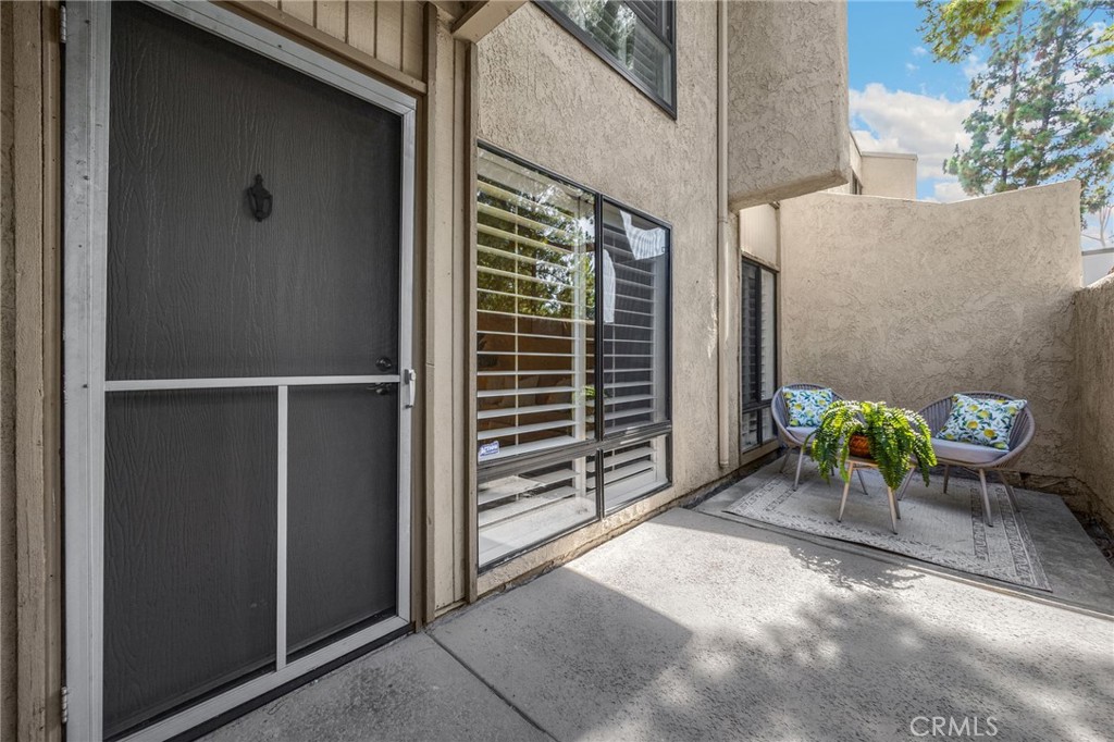 3020 Associated Road, Unit 110 Fullerton, CA 92835 - Photo 6 of 34 a view of backyard with a chair and table