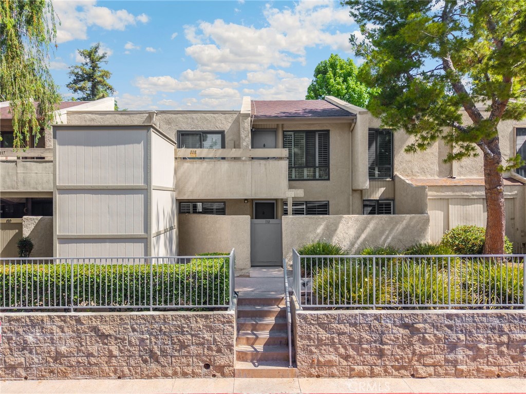 3020 Associated Road, Unit 110 Fullerton, CA 92835 - Photo 9 of 34 a view of a house with a wooden fence