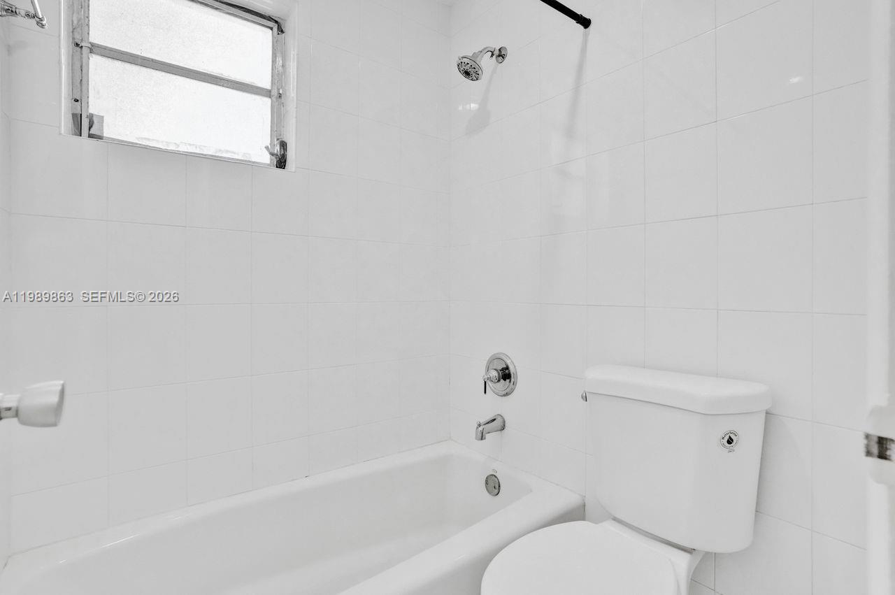 9454 Southwest 77th Avenue, Unit S1 Miami, FL 33156 - Photo 12 of 20 a bathroom with a bathtub and a shower