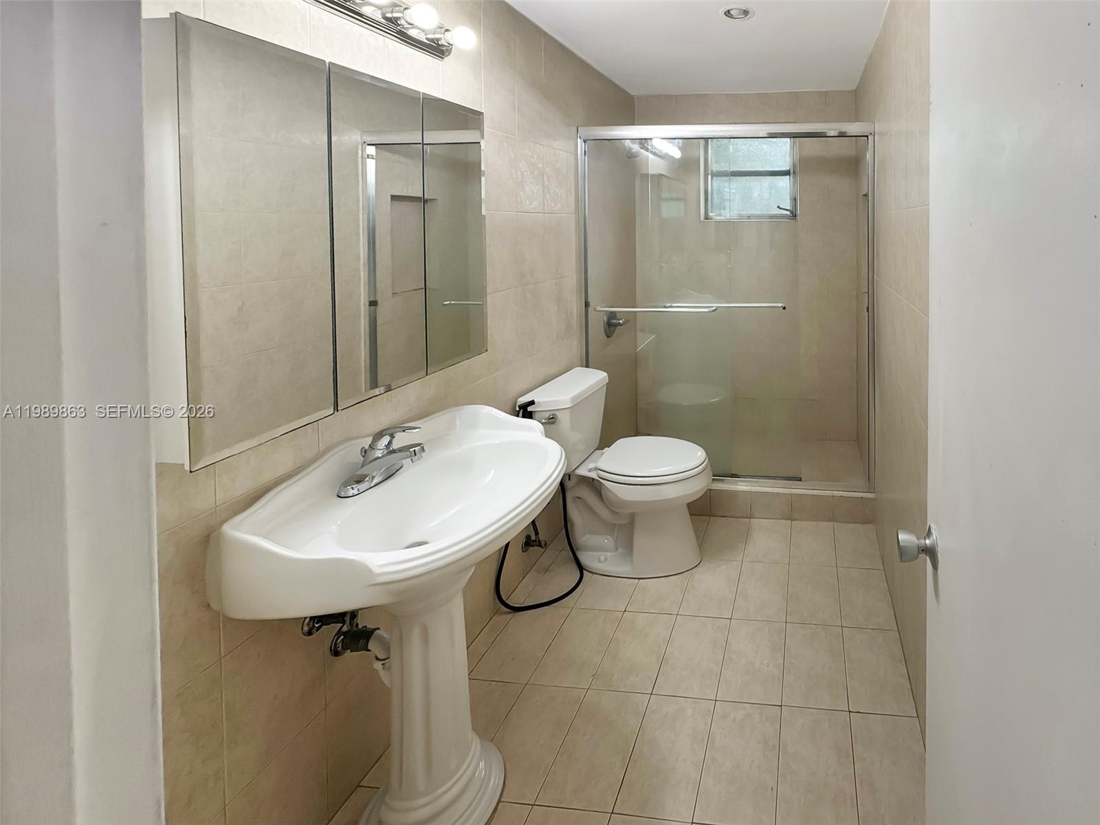 9454 Southwest 77th Avenue, Unit S1 Miami, FL 33156 - Photo 15 of 20 a bathroom with a sink toilet and shower