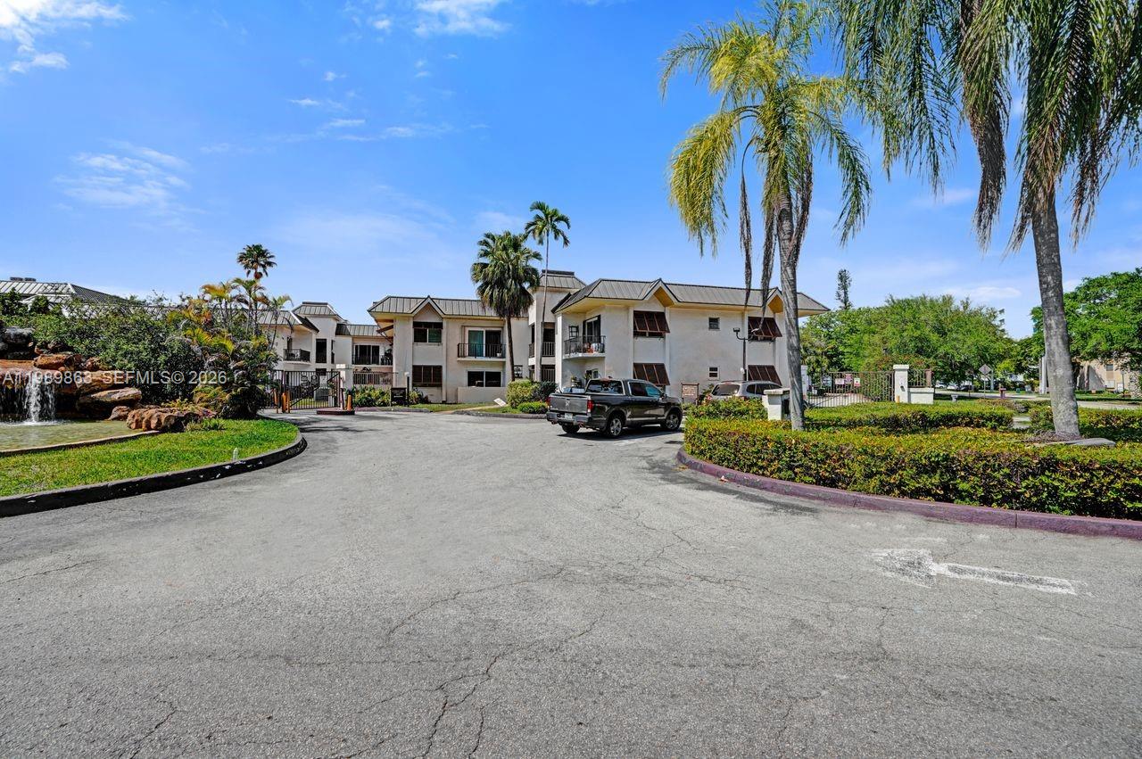 9454 Southwest 77th Avenue, Unit S1 Miami, FL 33156 - Photo 19 of 20 a multi story building with trees in front of it