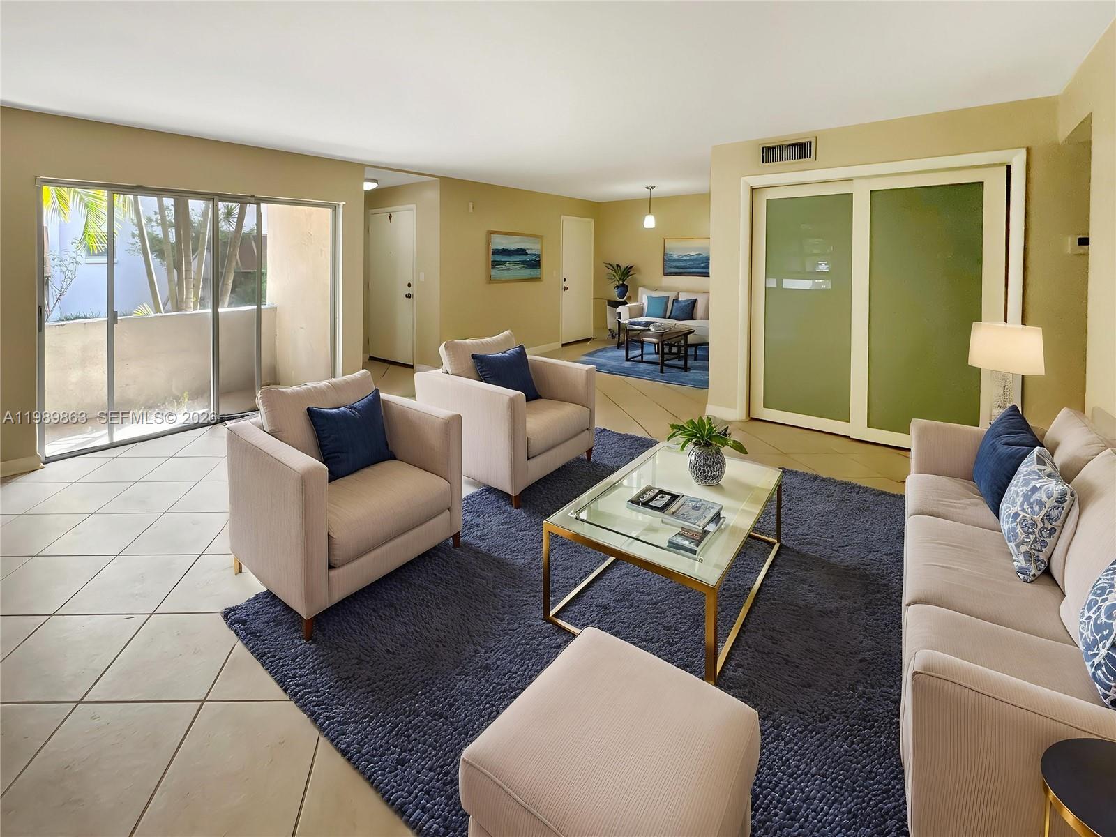 9454 Southwest 77th Avenue, Unit S1 Miami, FL 33156 - Photo 2 of 20 a living room with furniture and a large window