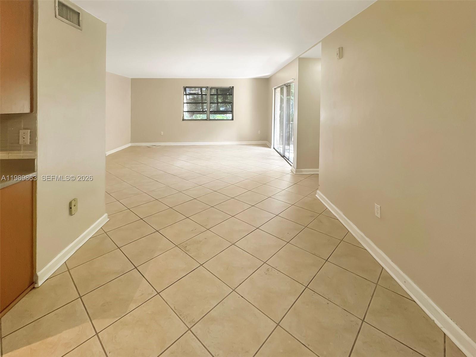 9454 Southwest 77th Avenue, Unit S1 Miami, FL 33156 - Photo 5 of 20 a view of an empty room and window