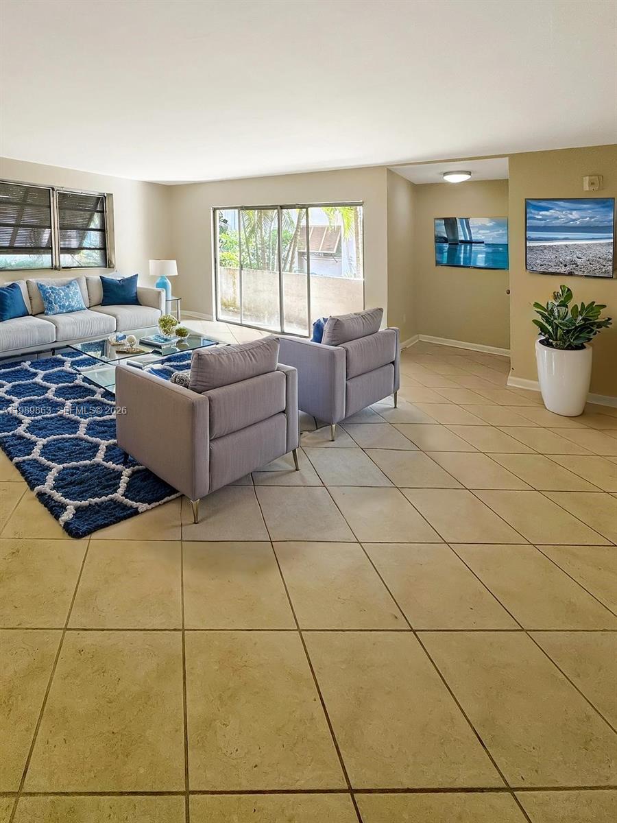 9454 Southwest 77th Avenue, Unit S1 Miami, FL 33156 - Photo 8 of 20 a living room with a couch and a table