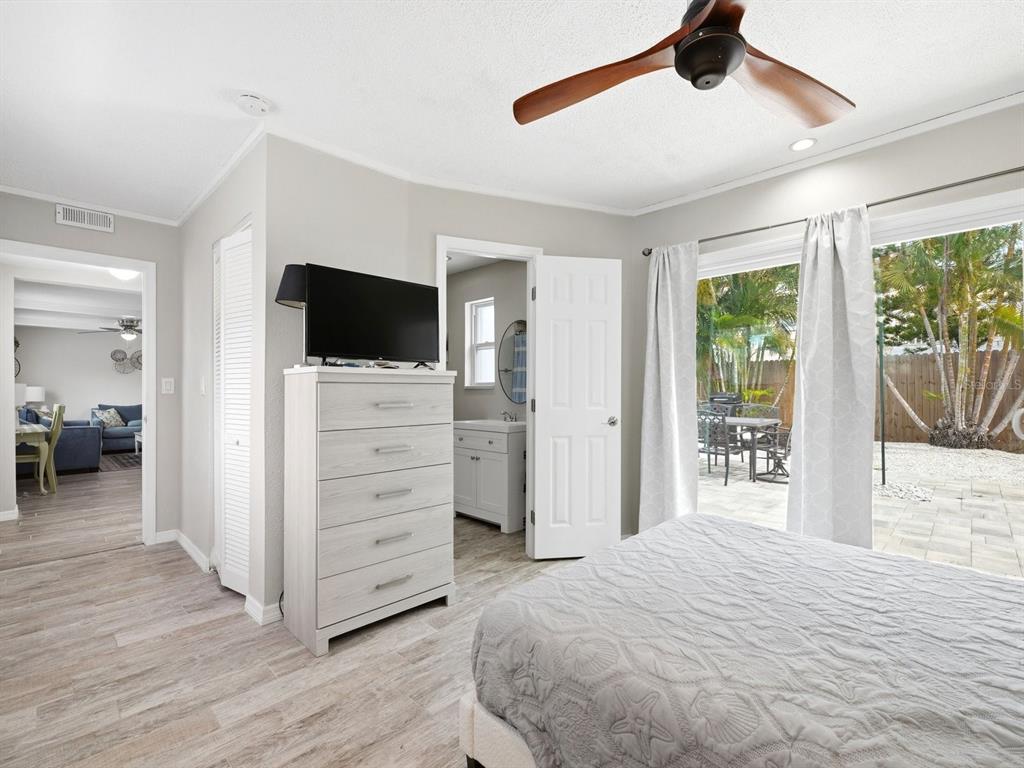 1207 1st Street Indian Rocks Beach, FL 33785 - Photo 19 of 60 a bedroom with a bed and a flat screen tv