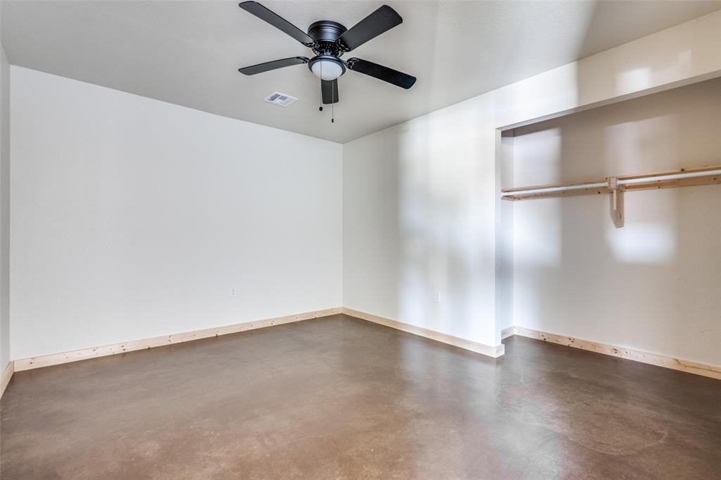 19029 Cabo Way, Unit 19033 Thackerville, OK 73549 - Photo 16 of 19 an empty room with wooden floor and windows