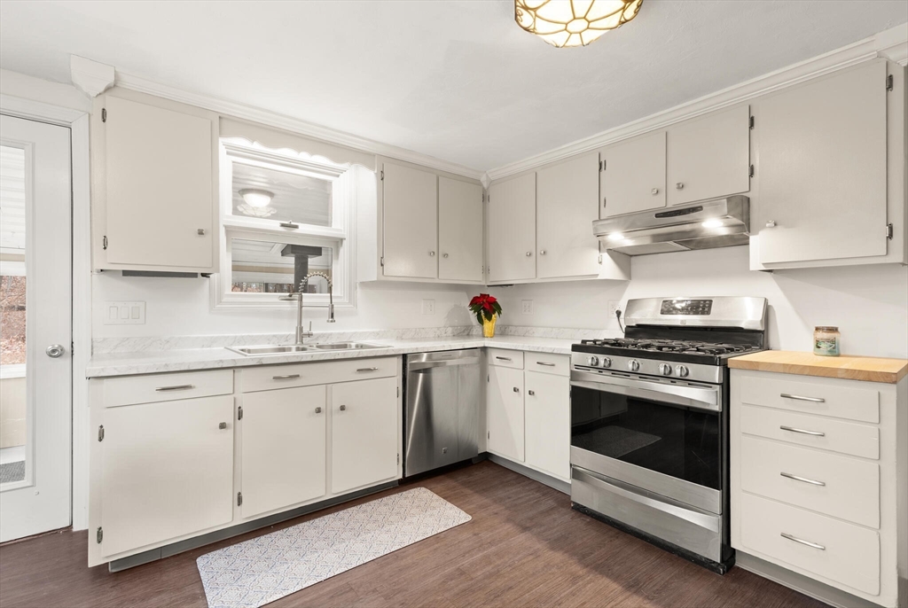 319 Pleasant Street Dunstable, MA 01827 - Photo 16 of 36 a kitchen with granite countertop white cabinets and white appliances