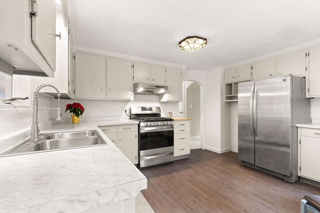 319 Pleasant Street Dunstable, MA 01827 - Photo 17 of 36 a kitchen with a refrigerator and a sink