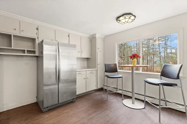 a kitchen with a refrigerator and furniture