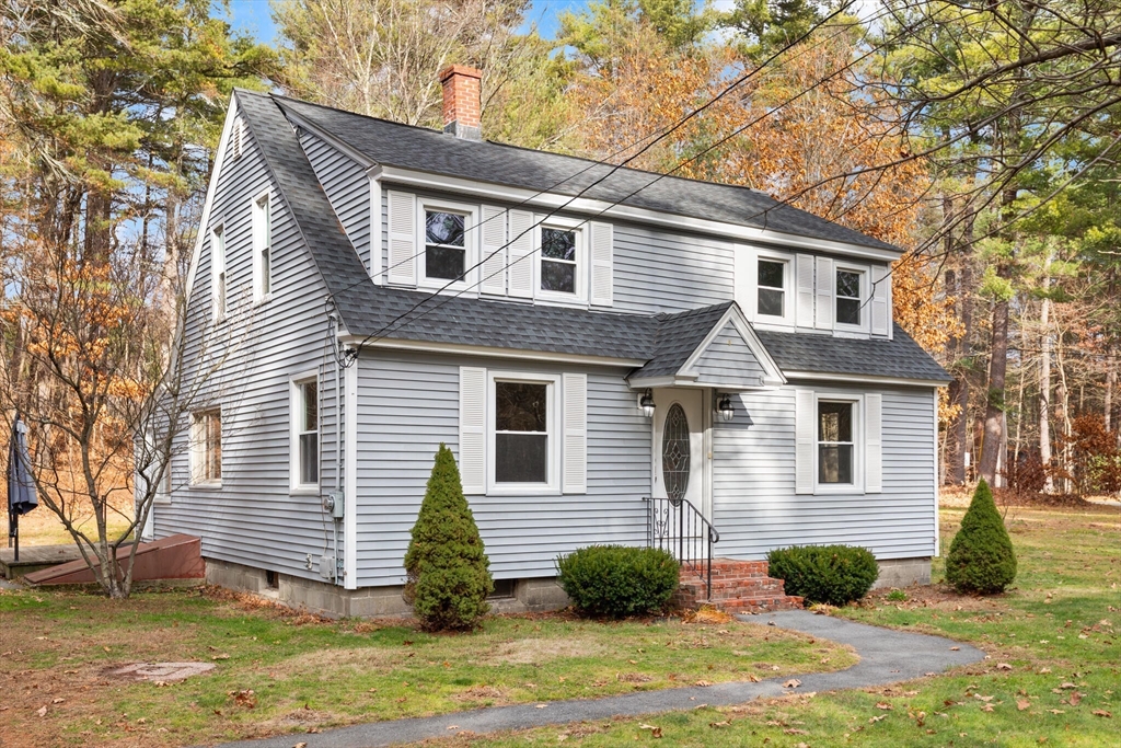 319 Pleasant Street Dunstable, MA 01827 - Photo 2 of 36 a front view of a house with garden