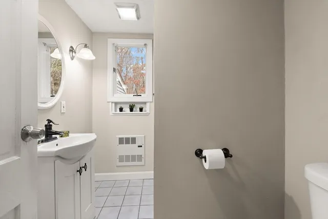 a bathroom with a sink a mirror and a window