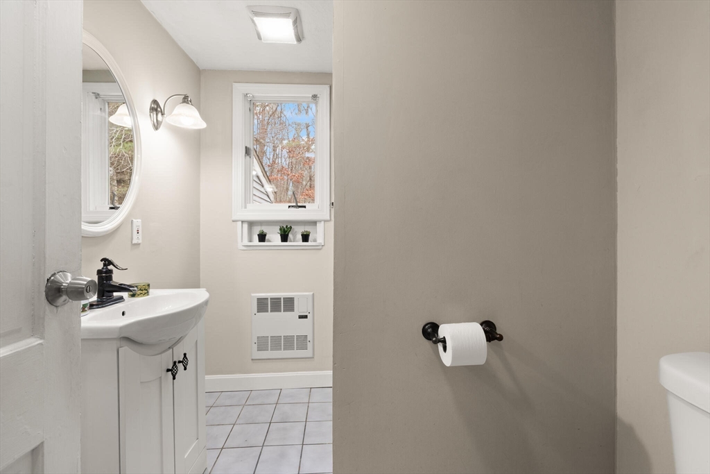319 Pleasant Street Dunstable, MA 01827 - Photo 22 of 36 a bathroom with a sink a toilet and mirror