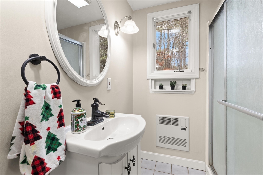 319 Pleasant Street Dunstable, MA 01827 - Photo 23 of 36 a bathroom with a sink a mirror and a window