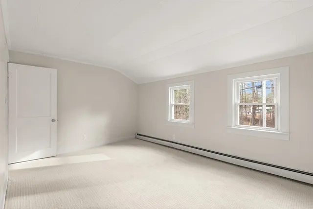 a bed room with a bed and a potted plant