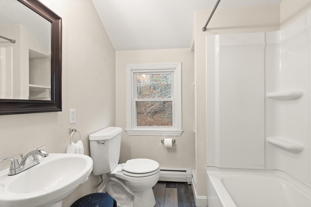 319 Pleasant Street Dunstable, MA 01827 - Photo 30 of 36 a bathroom with a toilet a sink and a bathtub