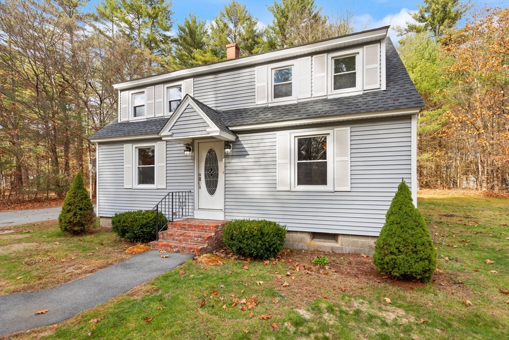 319 Pleasant Street Dunstable, MA 01827 - Photo 3 of 36 a front view of a house with a yard