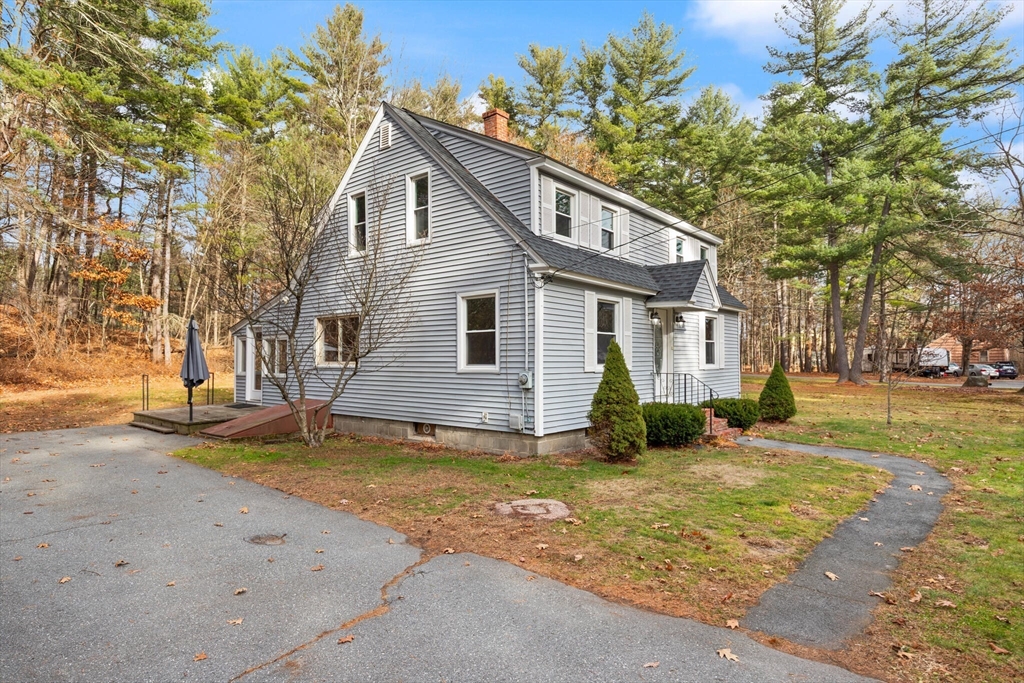 319 Pleasant Street Dunstable, MA 01827 - Photo 4 of 36 a view of a house with a yard and large tree