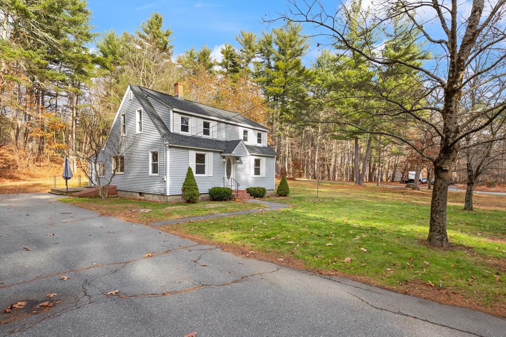 319 Pleasant Street Dunstable, MA 01827 - Photo 5 of 36 a front view of a house with a yard