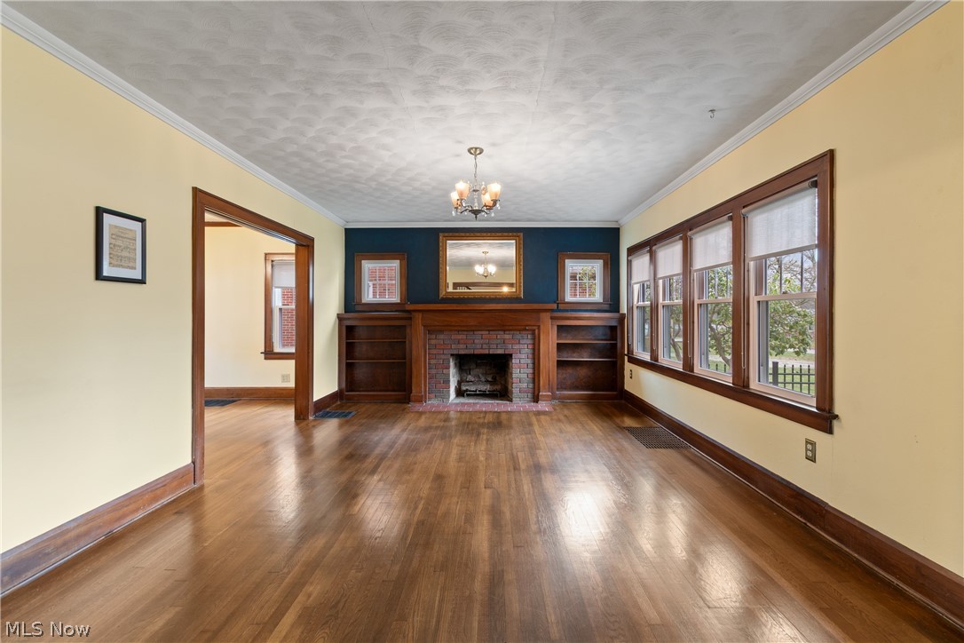 2214 Cleveland Road Wooster, OH 44691 - Photo 7 of 38 The living room is enormous and well lit with the "wall" of windows on the right. The hardwood floors and the gas log fireplace with built in bookshelves set the tone.