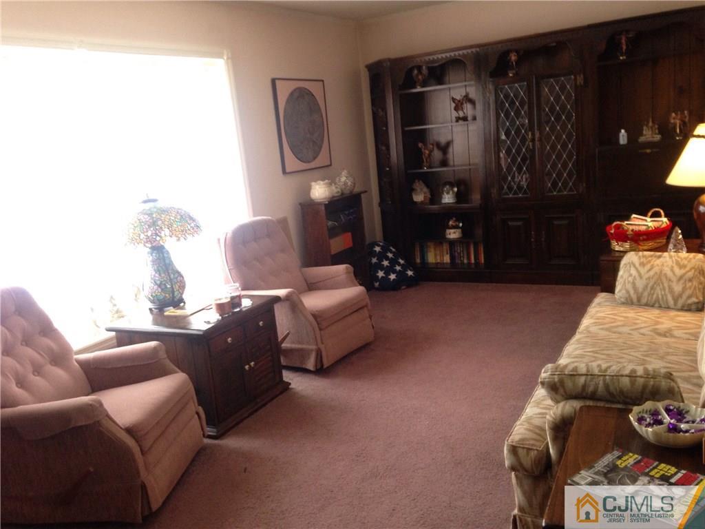 23 Williams Road Edison, NJ 08820 - Photo 2 of 21 a living room with furniture and a closet