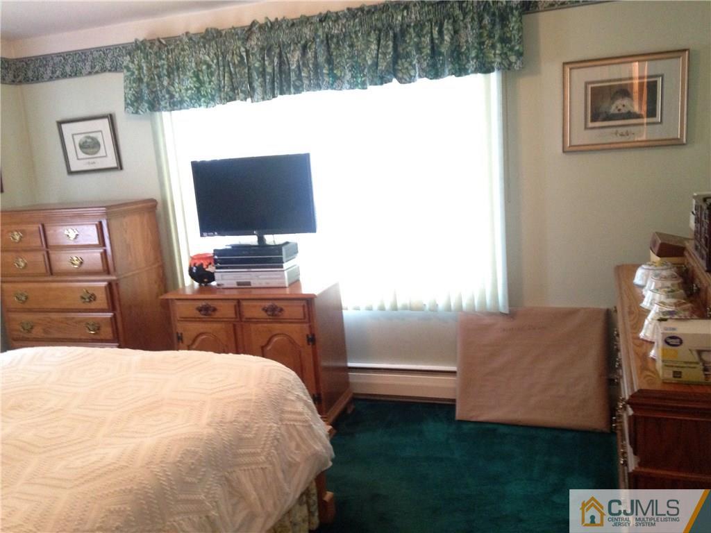 23 Williams Road Edison, NJ 08820 - Photo 12 of 21 a bedroom with a bed and a flat screen tv