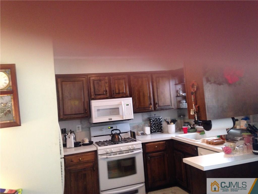 23 Williams Road Edison, NJ 08820 - Photo 20 of 21 a kitchen with a sink stove and cabinets