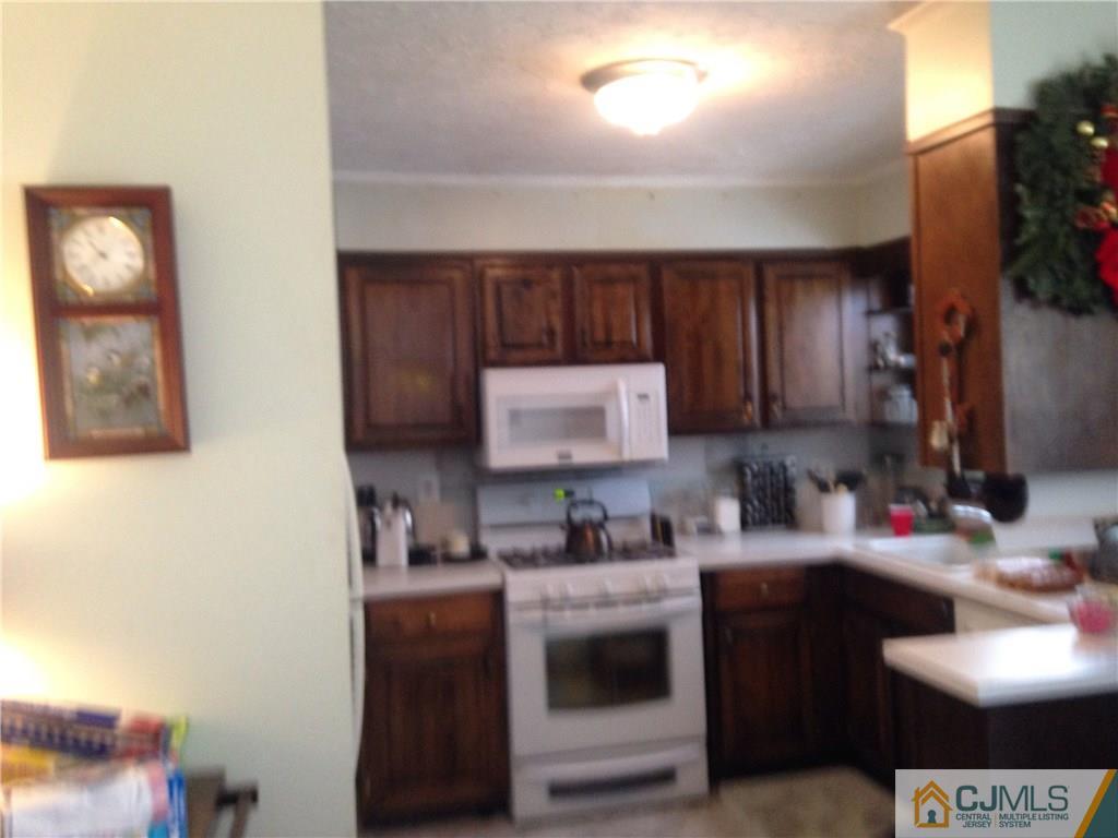 23 Williams Road Edison, NJ 08820 - Photo 4 of 21 a kitchen with stainless steel appliances granite countertop a sink stove and cabinets