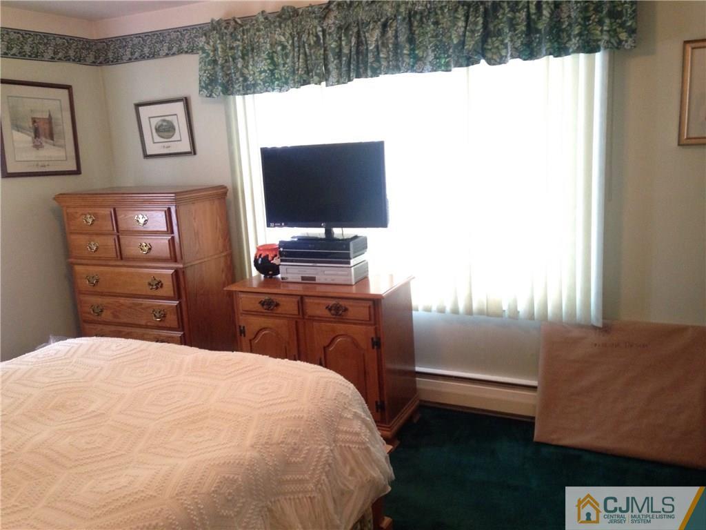 23 Williams Road Edison, NJ 08820 - Photo 6 of 21 a bedroom with a bed and a flat screen tv