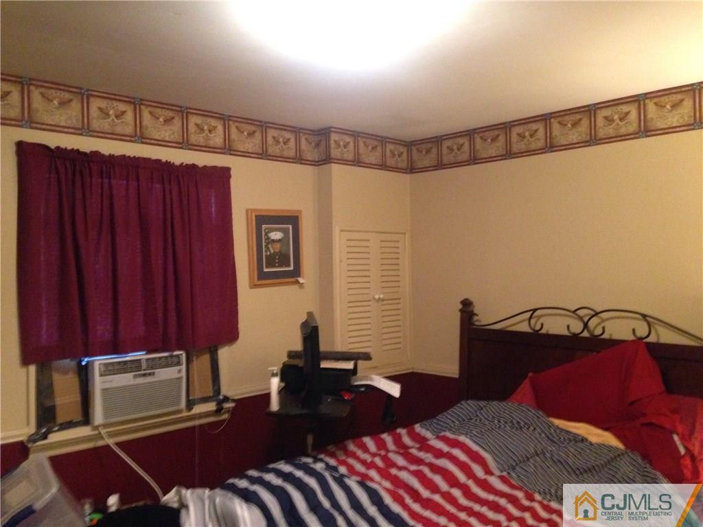 23 Williams Road Edison, NJ 08820 - Photo 8 of 21 a bedroom with a bed and a lamp with the dresser