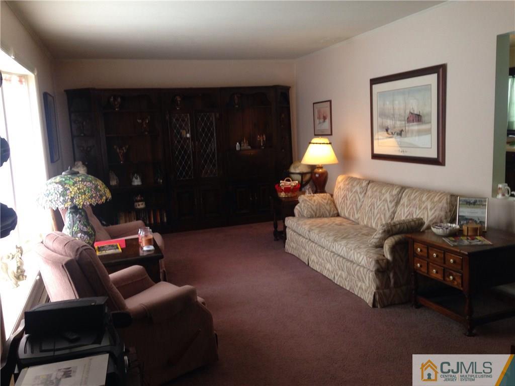 23 Williams Road Edison, NJ 08820 - Photo 10 of 21 a living room with furniture and a lamp