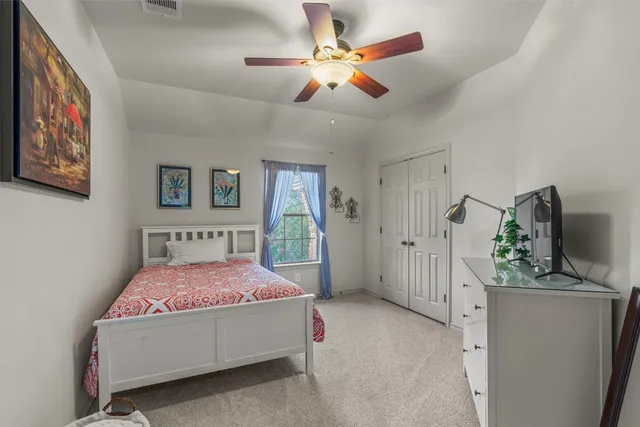 a living room with furniture and wall paintings