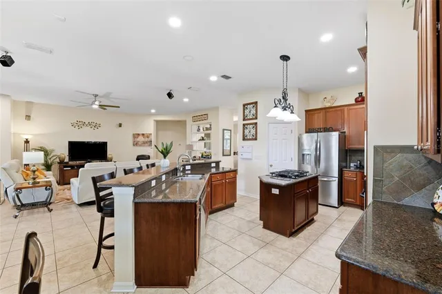 a kitchen with stainless steel appliances a stove a sink and a refrigerator