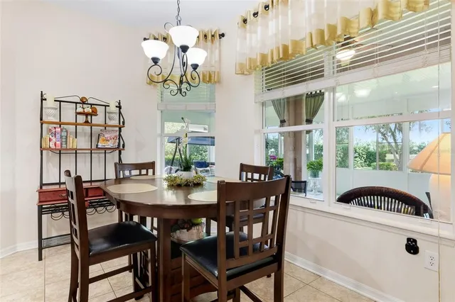 a view of a dining room with furniture and chandelier