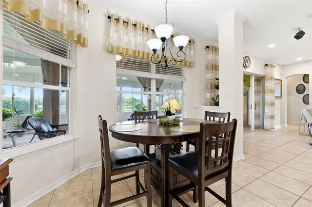 a spacious bedroom with a bed and a chandelier
