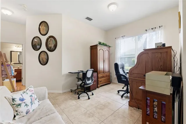 a view of a livingroom with workspace and a couch