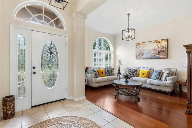 a living room with furniture and a chandelier