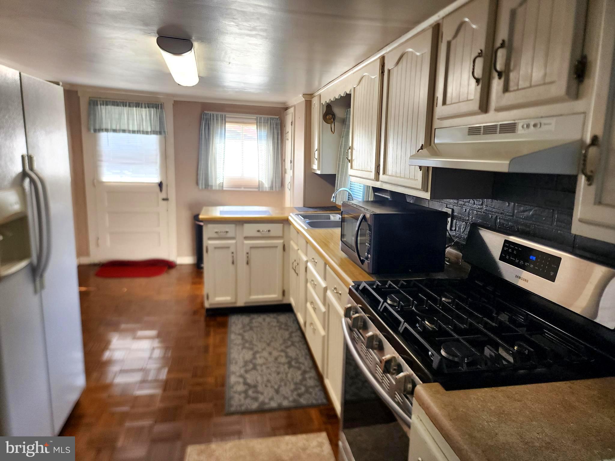 14403 Ellerslie Road Ellerslie, MD 21529 - Photo 2 of 34 a kitchen with stainless steel appliances granite countertop a stove and a refrigerator