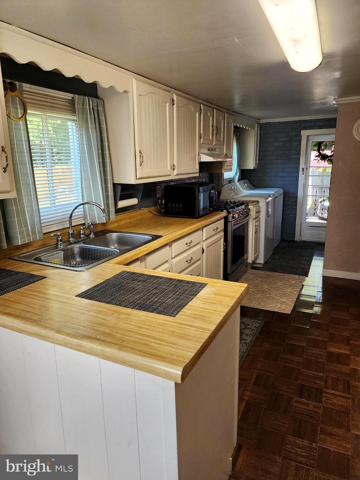 14403 Ellerslie Road Ellerslie, MD 21529 - Photo 21 of 34 a kitchen with kitchen island granite countertop a sink a stove and cabinets