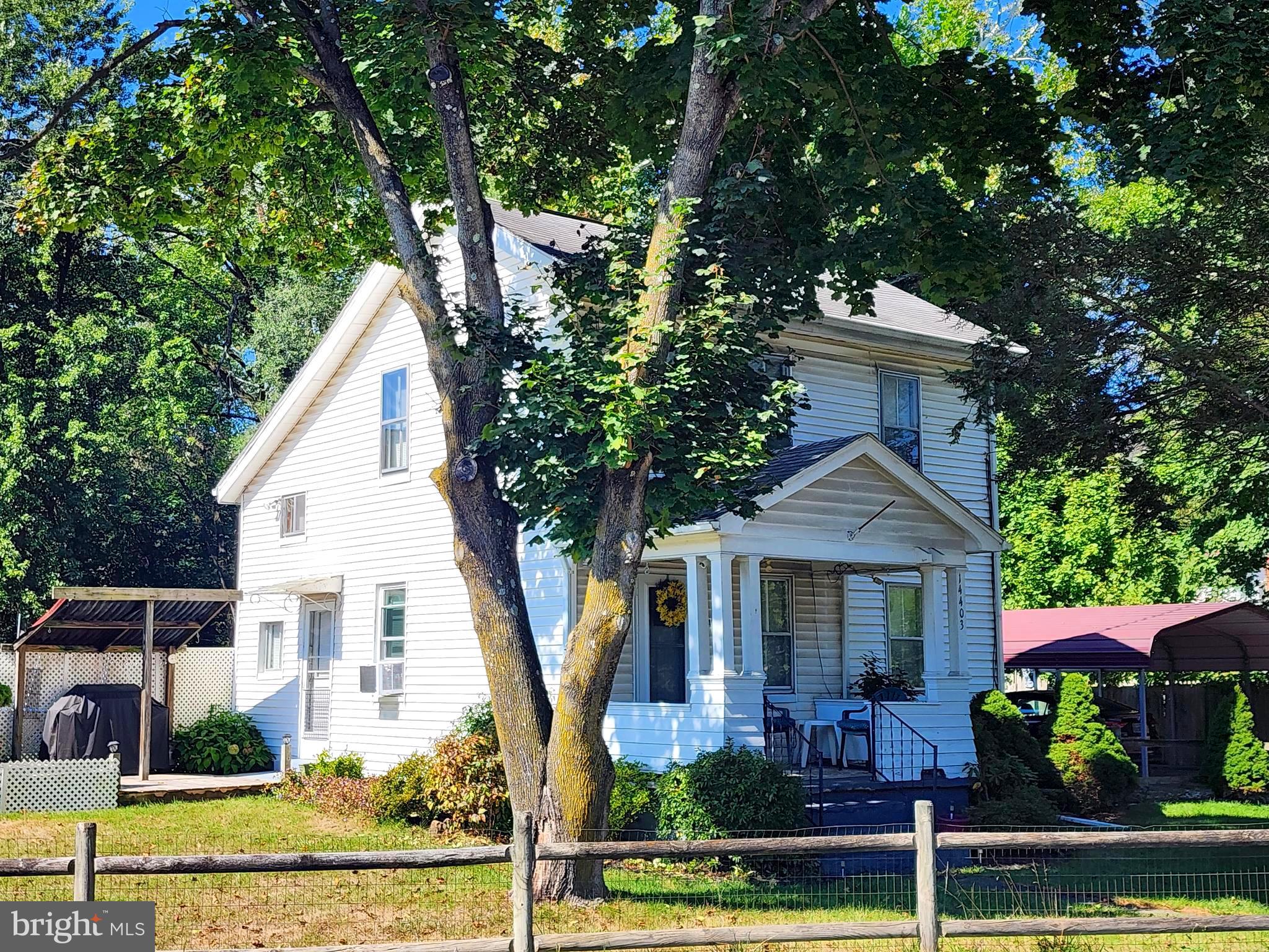 14403 Ellerslie Road Ellerslie, MD 21529 - Photo 7 of 34 a front view of a house with a yard
