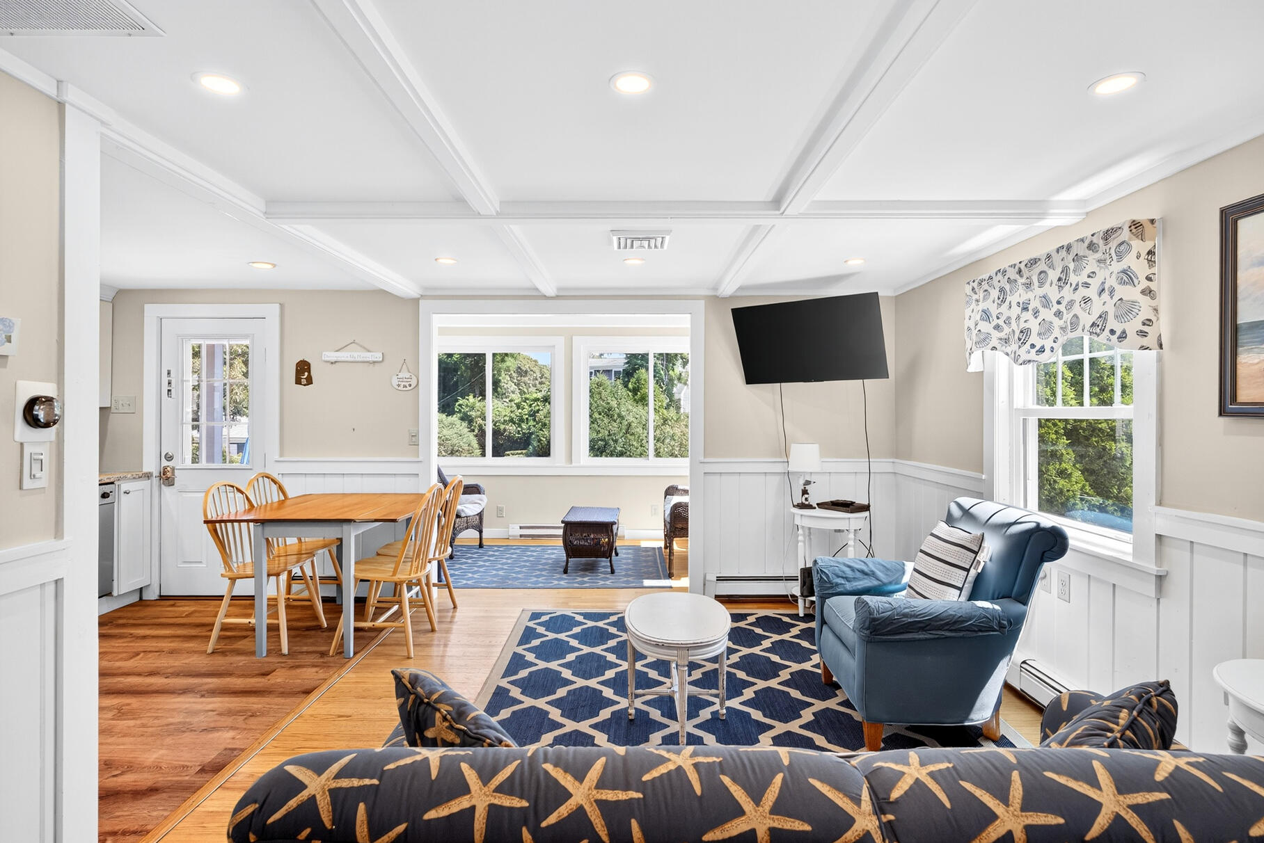 13 Garden Lane Dennis Port, MA 02639 - Photo 7 of 43 a living room with furniture a flat screen tv and a large window