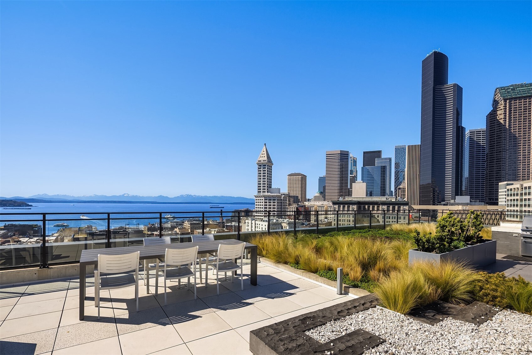 a view of a swimming pool with outdoor seating and city view