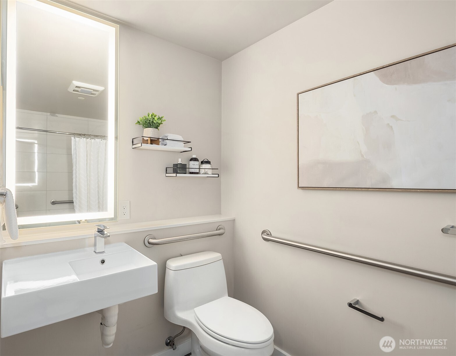 450 South Main Street, Unit 618 Seattle, WA 98104 - Photo 14 of 40 a bathroom with a toilet a sink and mirror