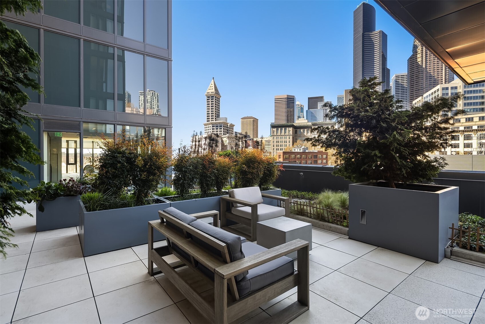 450 South Main Street, Unit 618 Seattle, WA 98104 - Photo 36 of 40 a view of a patio with couches and a fire pit and potted plants