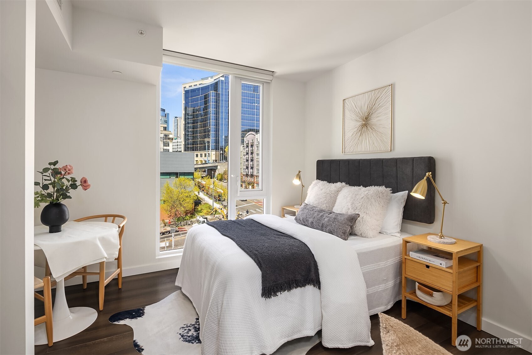 450 South Main Street, Unit 618 Seattle, WA 98104 - Photo 4 of 40 a bedroom with a bed and wooden floor