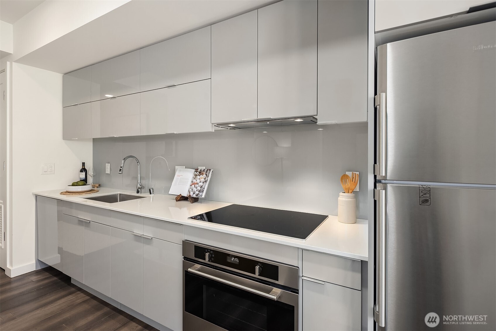 450 South Main Street, Unit 618 Seattle, WA 98104 - Photo 10 of 40 a kitchen with a sink and a refrigerator